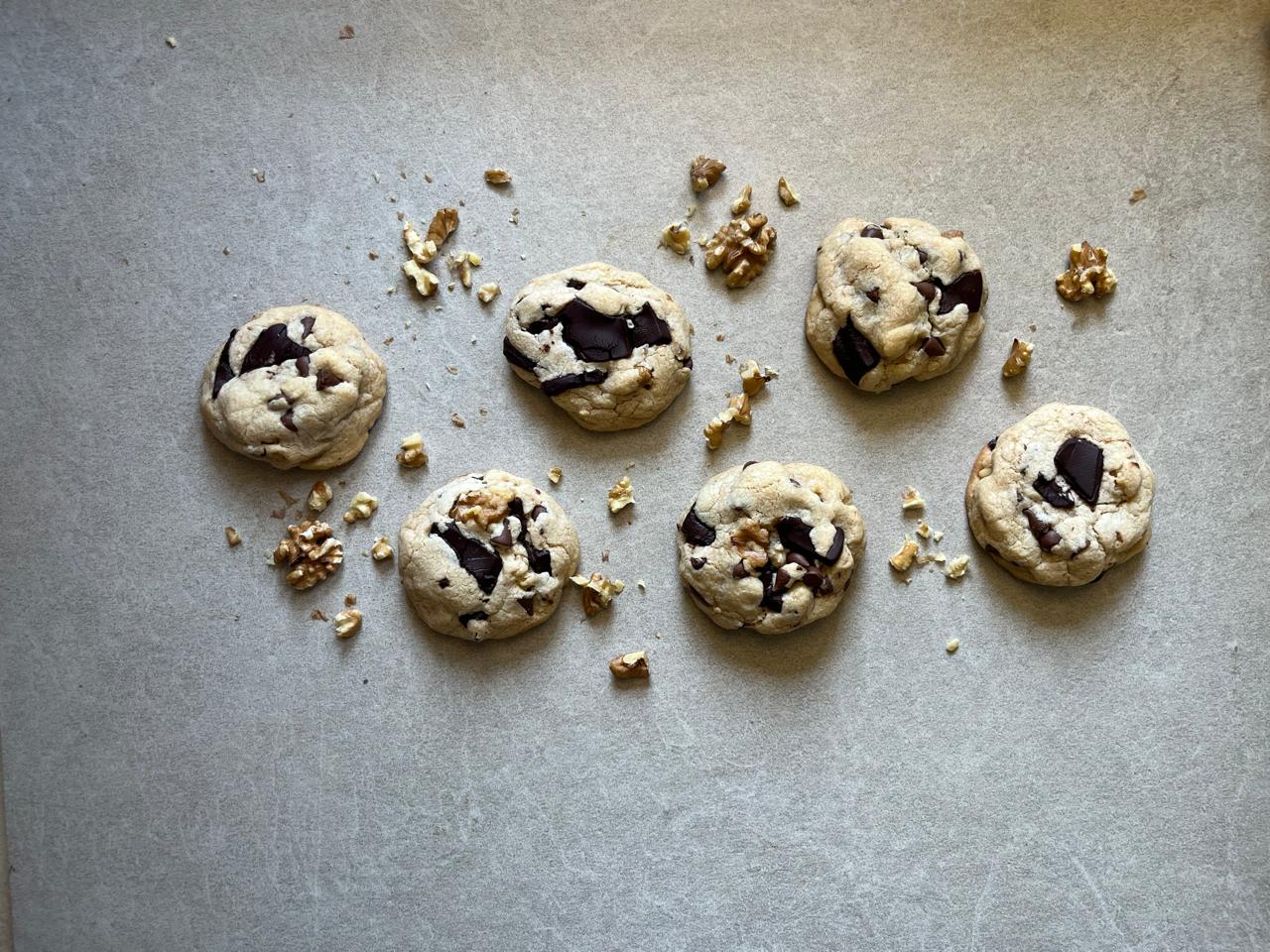 Six cookies laid out with walnuts in between them. They're the chunkiest cookie you've ever seen in Dubai